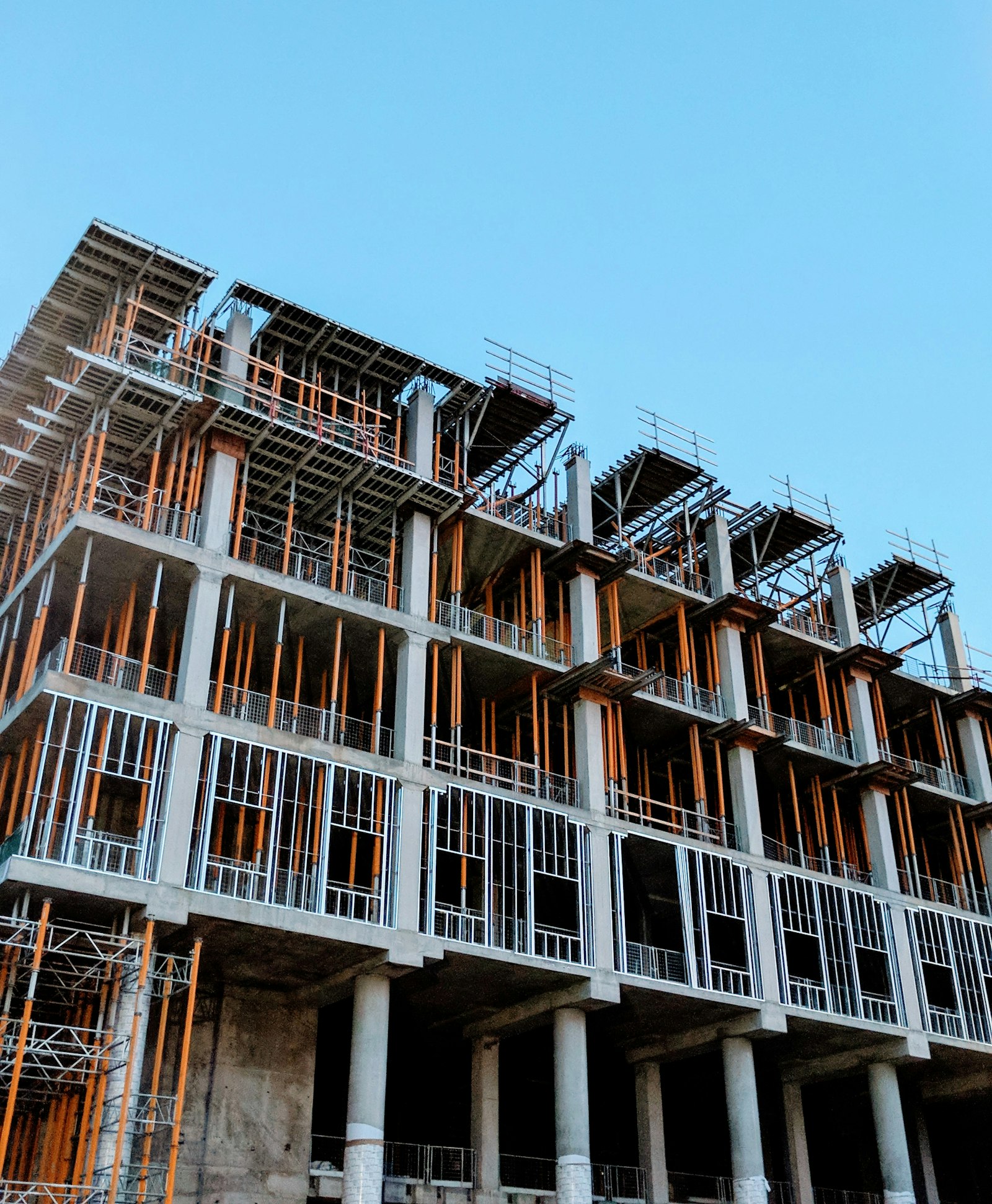 Post-tensioning strands being stressed on a newly poured slab